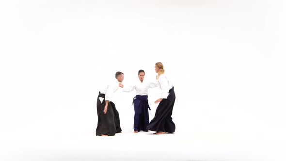 Two Guys and Girl Performing Aikido Techniques, Isolated on White