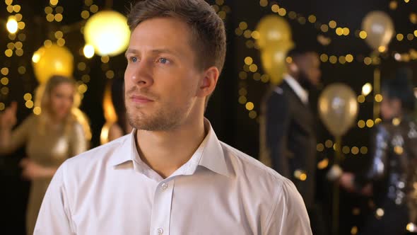 Worried Handsome Man Waiting for Girlfriend at Party Looking Around, Loneliness