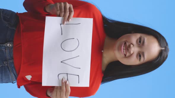 Woman Holding Up Love Sign