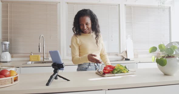 Latin American Young Woman Makes a Video Call or a Cooking Blog