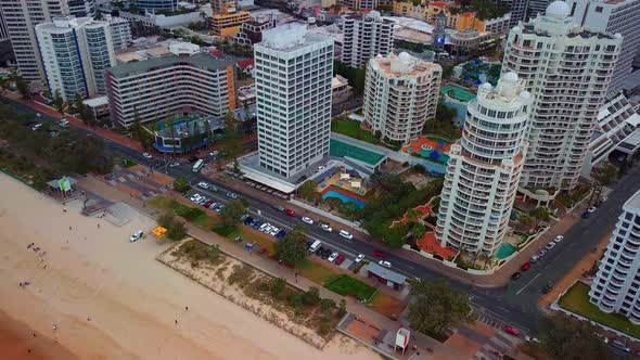 Coastal Road Traffic And Tourists On Sandy Shore At Gold Coast City In Queensland, Australia. Aerial