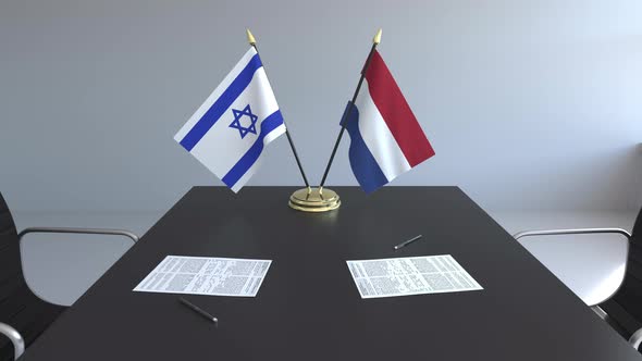 Flags of Israel and Netherlands on the Table