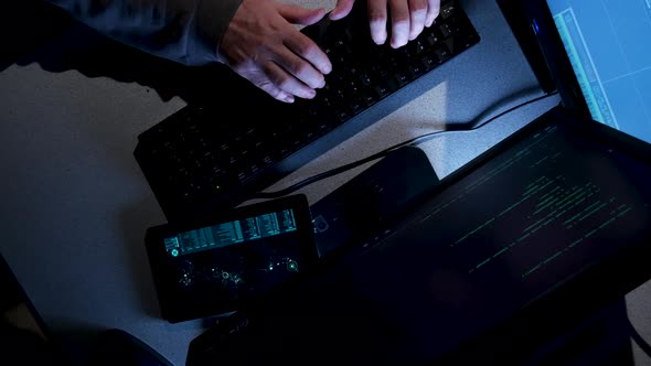 Overhead shot of computer hacker typing code