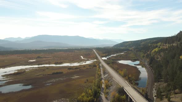 Aerial View of a Scenic Highway Around Mountains