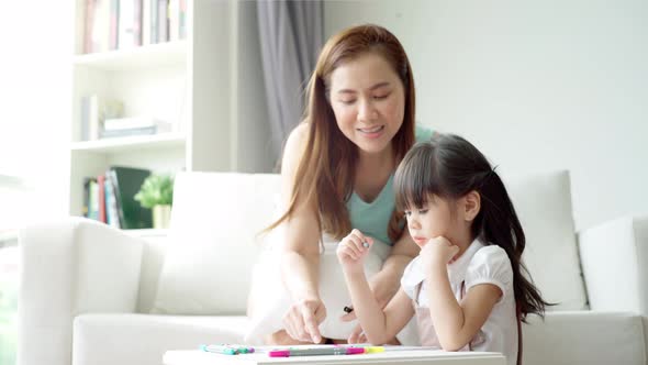 An Asian mother Teaching Her Daughter to Draw 05