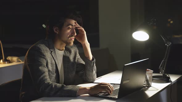 People Work Alone in the Office Staying Up Late