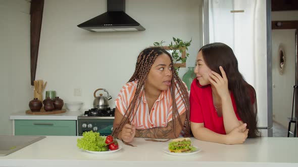 African American Woman Choosing Burger or Healthy Food to Eat Indoors