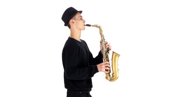 Performs Solo on Saxophone Talented Saxophonist. White Background in Studio