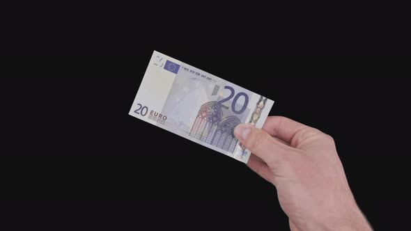 Male Hand Shows a Banknote of 20 Euros with Alpha Channel