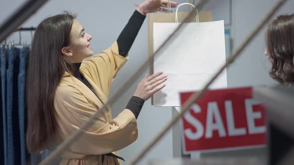 Satisfied Caucasian Woman Taking Shopping Bags with Purchase Smiling Thanking Leaving Shop