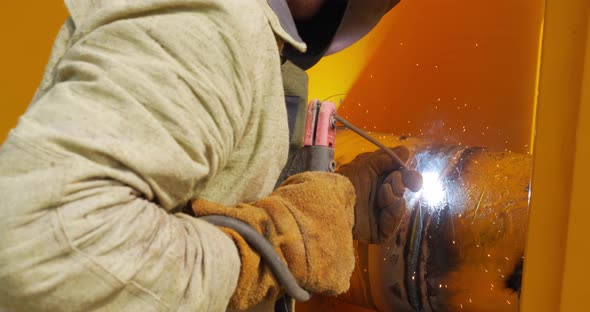 The Gasman Welds The Pipes At The Factory With A Welding Machine