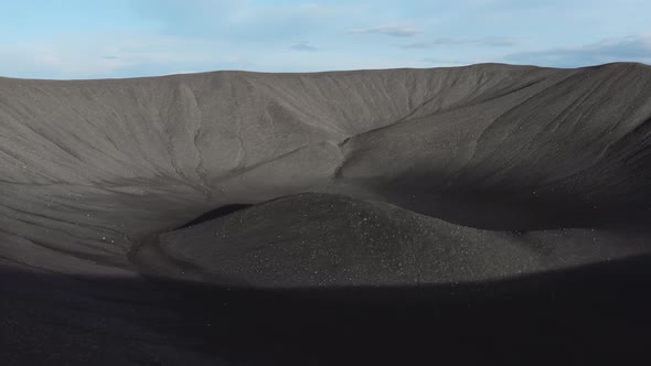 Drone Pulling Back Over Large Black Crater Of Iceland Volcano