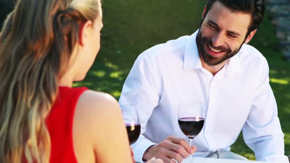 Couple toasting glasses of wine in outdoor restaurant 4k