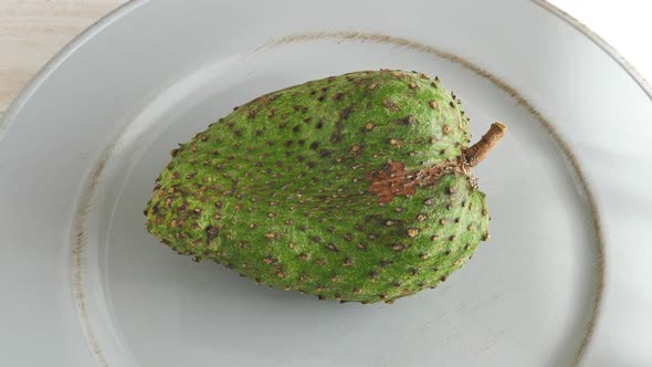 Closeup of Green Soursop Graviola, Exotic, Tropical Fruit Guanabana on Plate