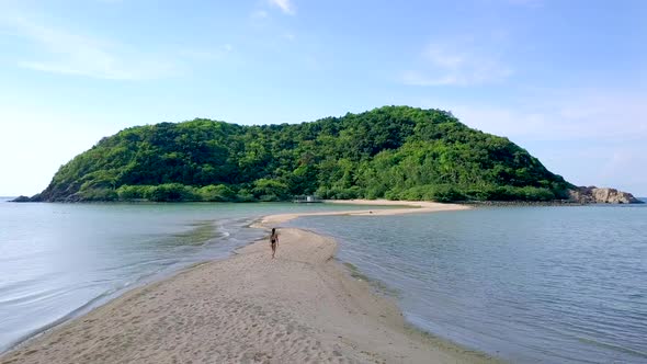 Young Pretty Woman in Black Swimsuit Walking Alone on a SandbarThailand