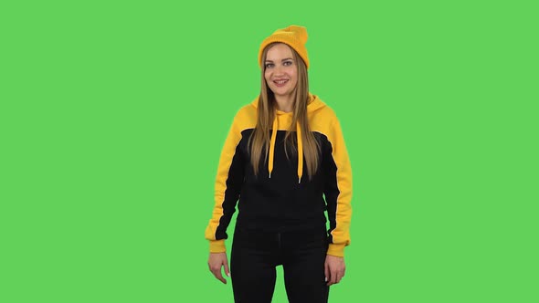 Modern Girl in Yellow Hat Is Making Sign Ok. Green Screen