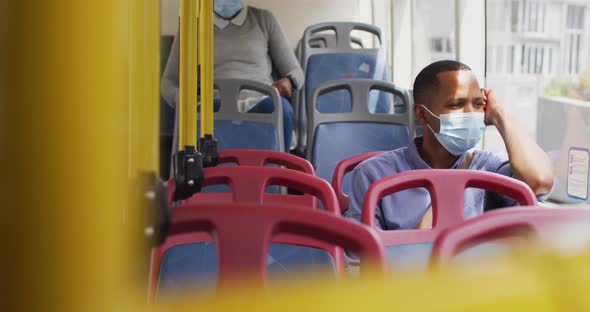 African american man with face mask sitting in bus