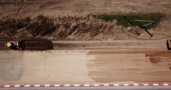 Road Construction Site Near the Highway with Machinery, Bulldozer, Excavation From Above, Video, Top