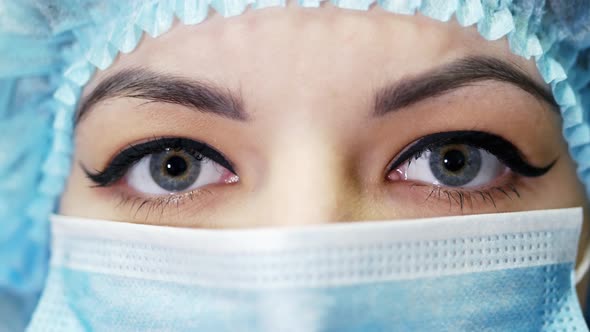 Close-up Portrait of a Female Doctor, Wearing Surgical Mask and Looking at Camera