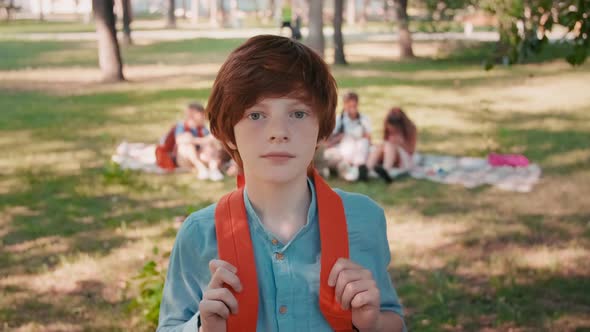 Cute Schoolboy Posing in Park