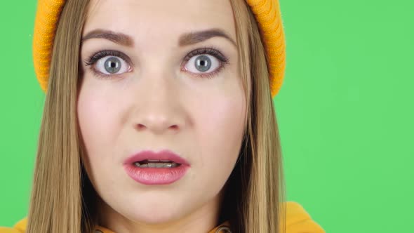 Woman in a Yellow Hat Scared and Looking Straight. Close Up. Green Screen