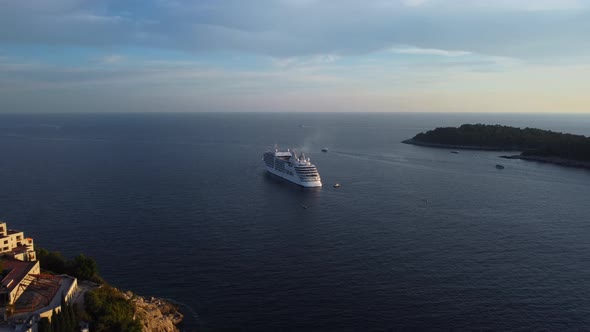 Beautiful aerial shot of a cruise ship on the ocean at sunset