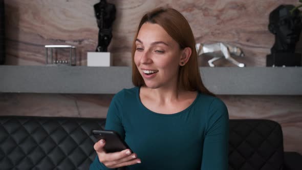 Surprised Woman Face Looking at Smartphone