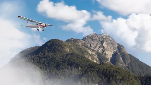 Airplane Flying Over the Mountain Landscape During Cloudy Day