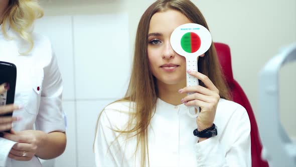 Young woman checking eyesight.