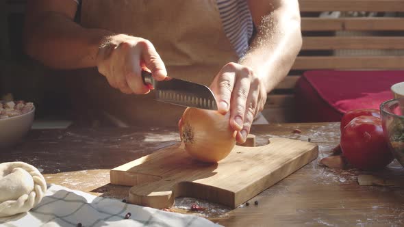 Men's Hands Cutting Onion on Wooden Board. Chef with Knife Cut Vegetables, Mexican or Latin American