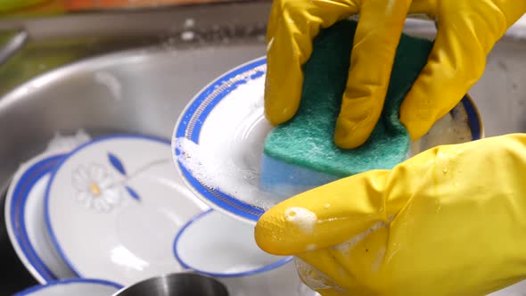 Hand Washing Dishes In Kitchen Sink