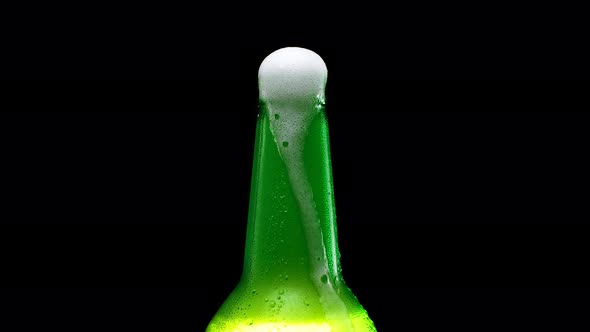 Beer Foam Flows Down a Bottle