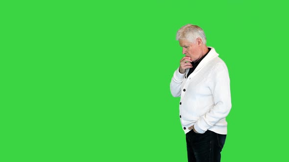 Senior Mature Man Thinking or Trying Hard To Remember Something on a Green Screen Chroma Key