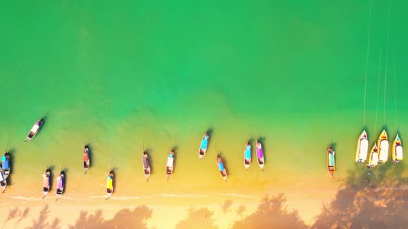 Aerial top view over sandy beach with turquoise water