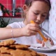 Little Girl is Takes Icing with Culinary Brush and Applies It Onto Gingerbread - VideoHive Item for Sale