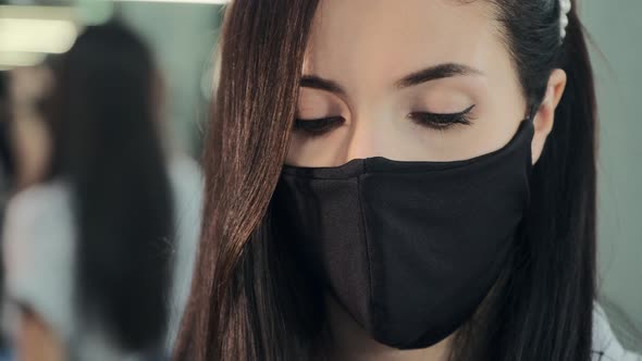 Beautician in Protective Mask Near Mirror in Cosmetic Salon