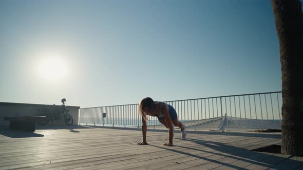 Sportswoman Workout Outdoor on Seaside  She Make Burpee Exercise