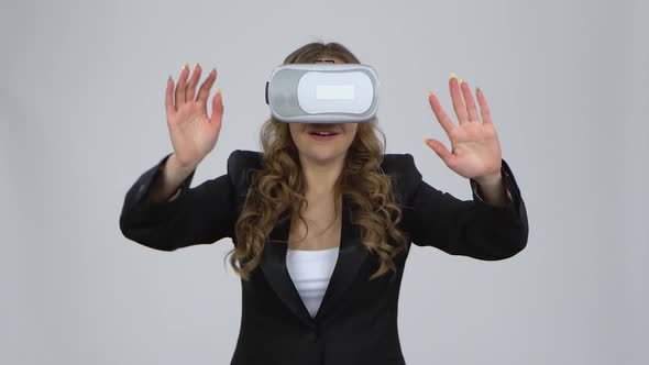 Happy Young Woman with Virtual Reality Headset or 3d Glasses on Gray Background at Studio.