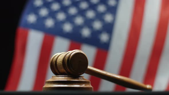 Judge's Gavel on Block Against American Flag Waving in United States Court Room