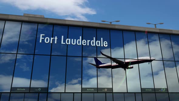 Airplane landing at Fort Lauderdale Florida, USA airport mirrored in terminal