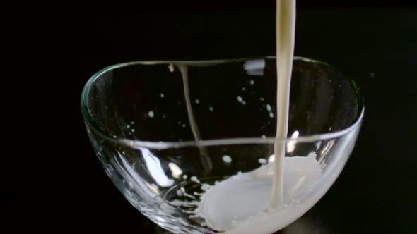 Pouring milk into a glass bowl, Ultra Slow Motion