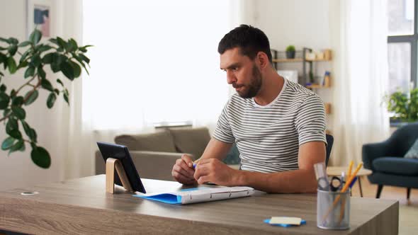 Man with Tablet Pc Having Video Call at Home