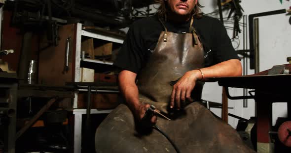 Portrait of welder sitting with welding arch