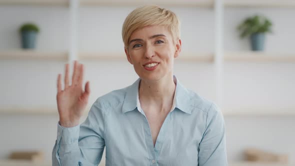 Webcam Pov Shot of Positive Mature Woman Waving Hand to Camera Greeting Interlocutors Online Sitting