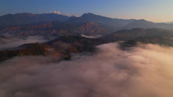 4K aerial view from a drone flying over the valley, fog in the morning.
