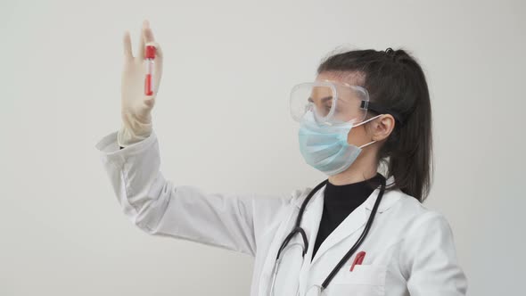 Female Scientist, Comparing Blood Samples or Serums. Testing Patients for Coronavirus in Laboratory