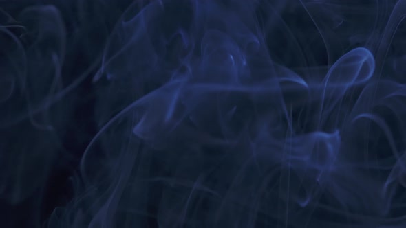 Abstract Smoke Cloud. Blue Smoke Slowly Floating Through Space Against Black Background. Close Up