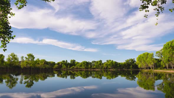 Scenic Lake with Cloud Reflections Tilt Up Timelapse