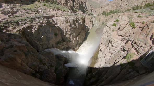 View of water rushing out of Buffalo Bill Dam and flowing through the canyon