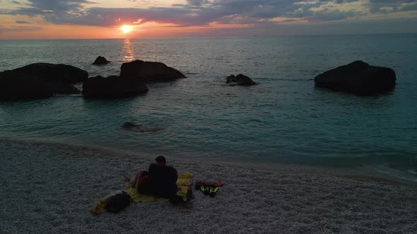 Couple Meeting Sunset Above the Sea at the Beach